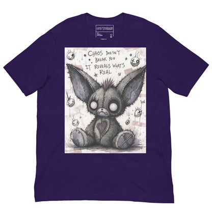 Purple unisex t-shirt with the 'Chaos' goth graphic: a stitched gray big-eared creature with button eyes, with the words "Chaos doesn't break you, it reveals what's real"
