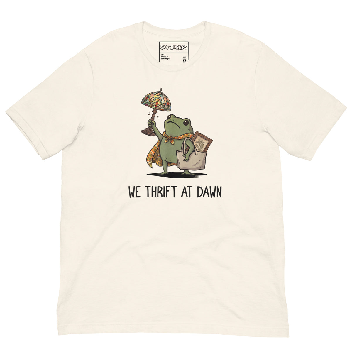 Funny "We Thrift At Dawn Frog" graphic printed on a vintage white unisex tee, front view