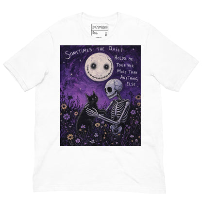 White unisex t-shirt with the 'The Quiet Heals' goth graphic: a skeleton and a black cat in a purple flower field under a smiling moon, with the words "Sometimes the quiet holds me together more than anything else"