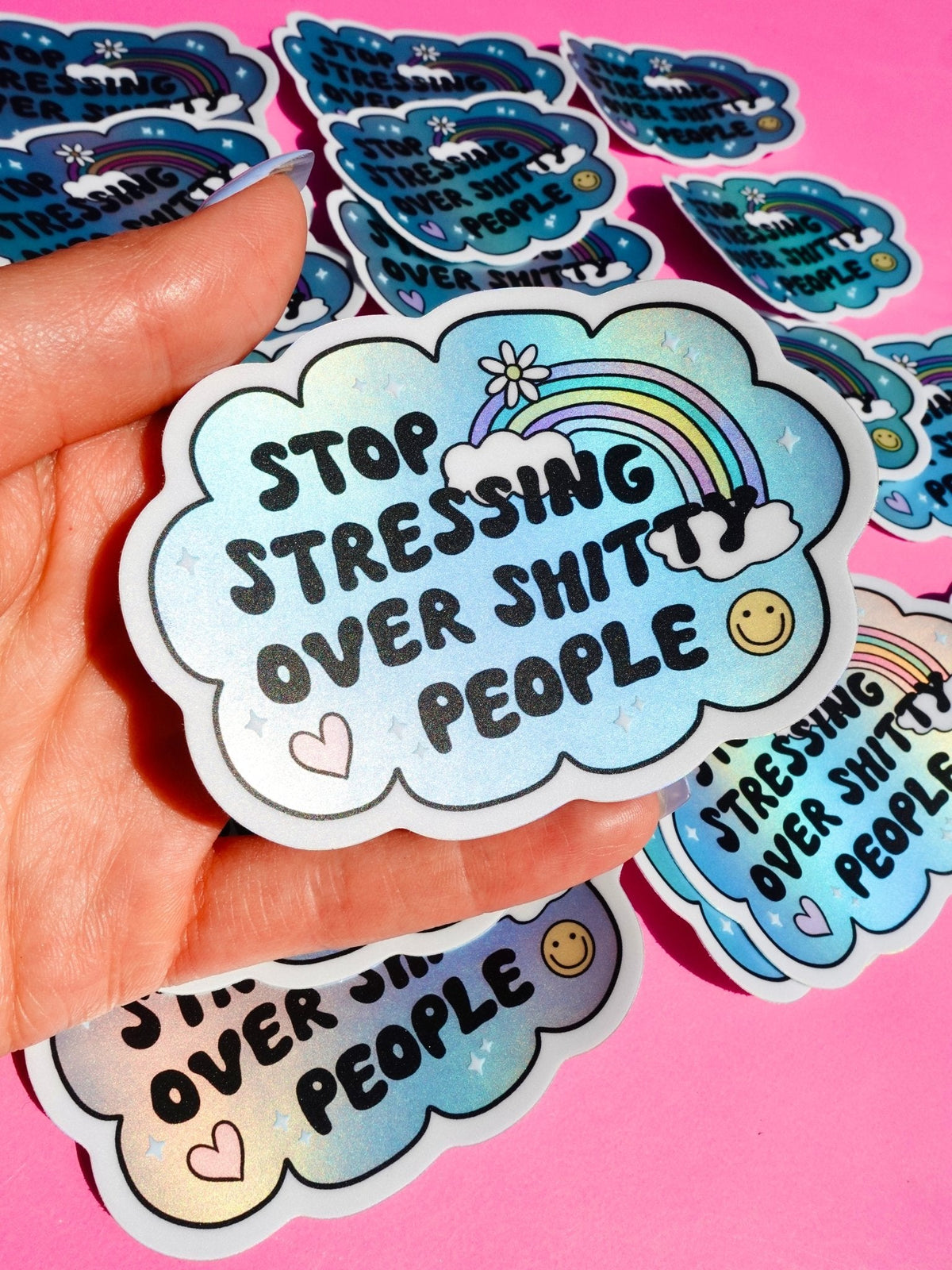 Funny Blue cloud sticker showing rainbow arch, stars, hearts, and “Stop stressing over shitty people”
