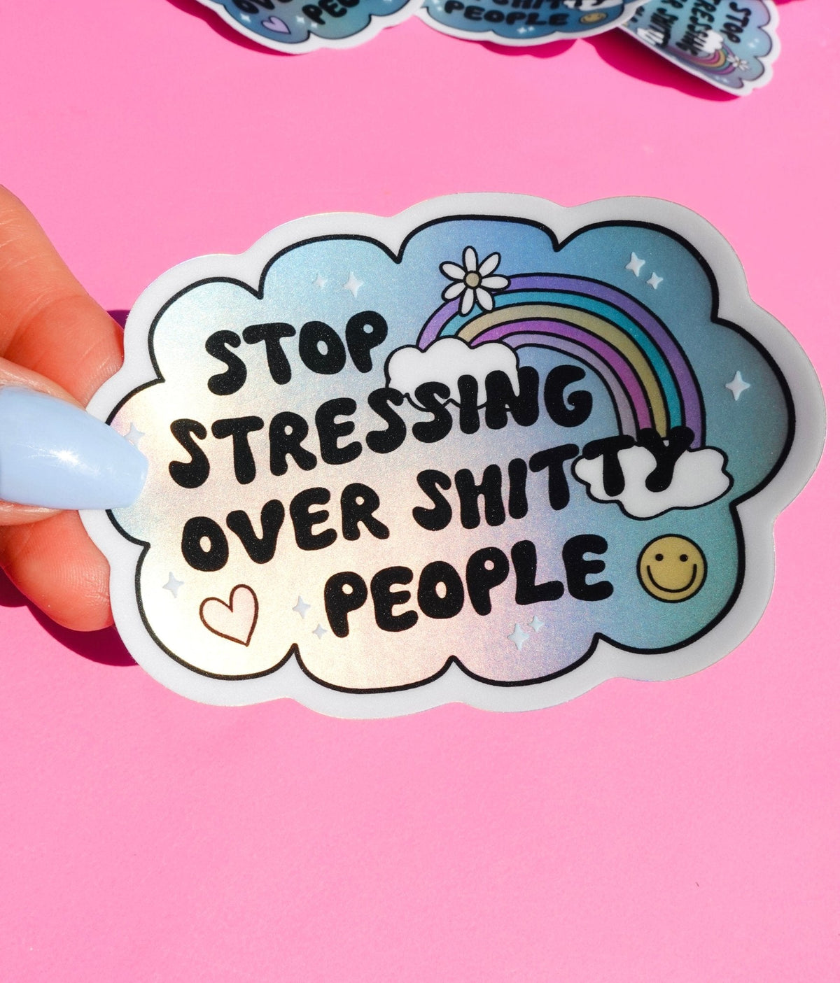 Funny Handheld blue cloud sticker with rainbow and hearts, text “Stop stressing over shitty people”