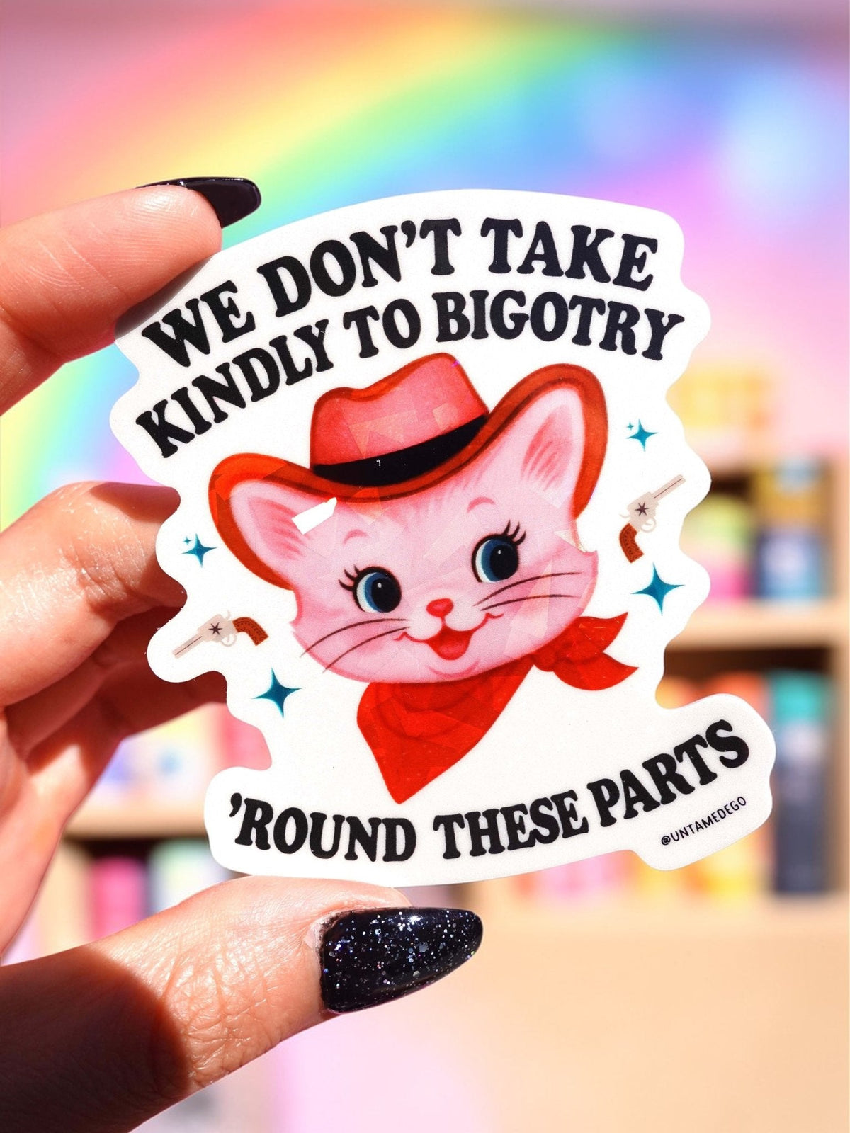 Funny Cat anti-bigotry sticker reading “WE DON'T TAKE KINDLY TO BIGOTRY” and “ROUND THESE PARTS”