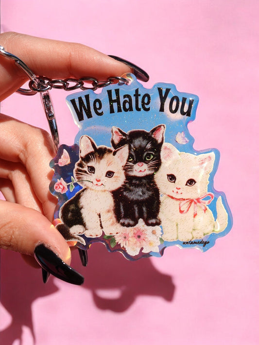 Funny Rainbow iridescent kitten keychain with 'We Hate You' and cat faces