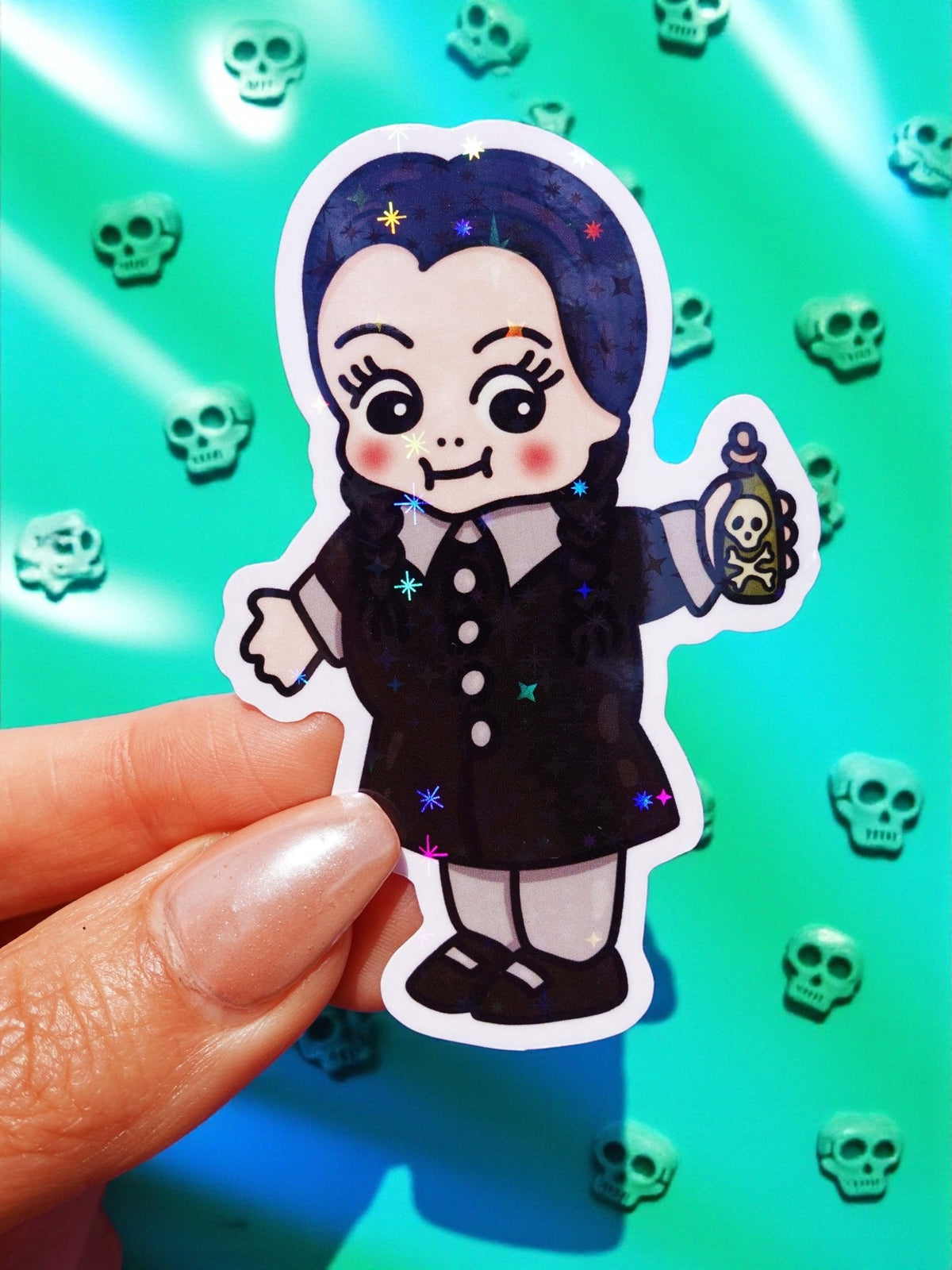 Funny Cute gothic character sticker, dark hair witch outfit holding a skull, starry halo background