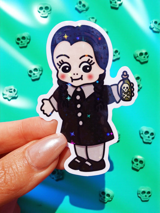 Funny Cute gothic character sticker, dark hair witch outfit holding a skull, starry halo background