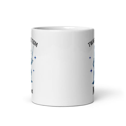 White glossy mug back with partial blue stars and 'Twas the Tism' text