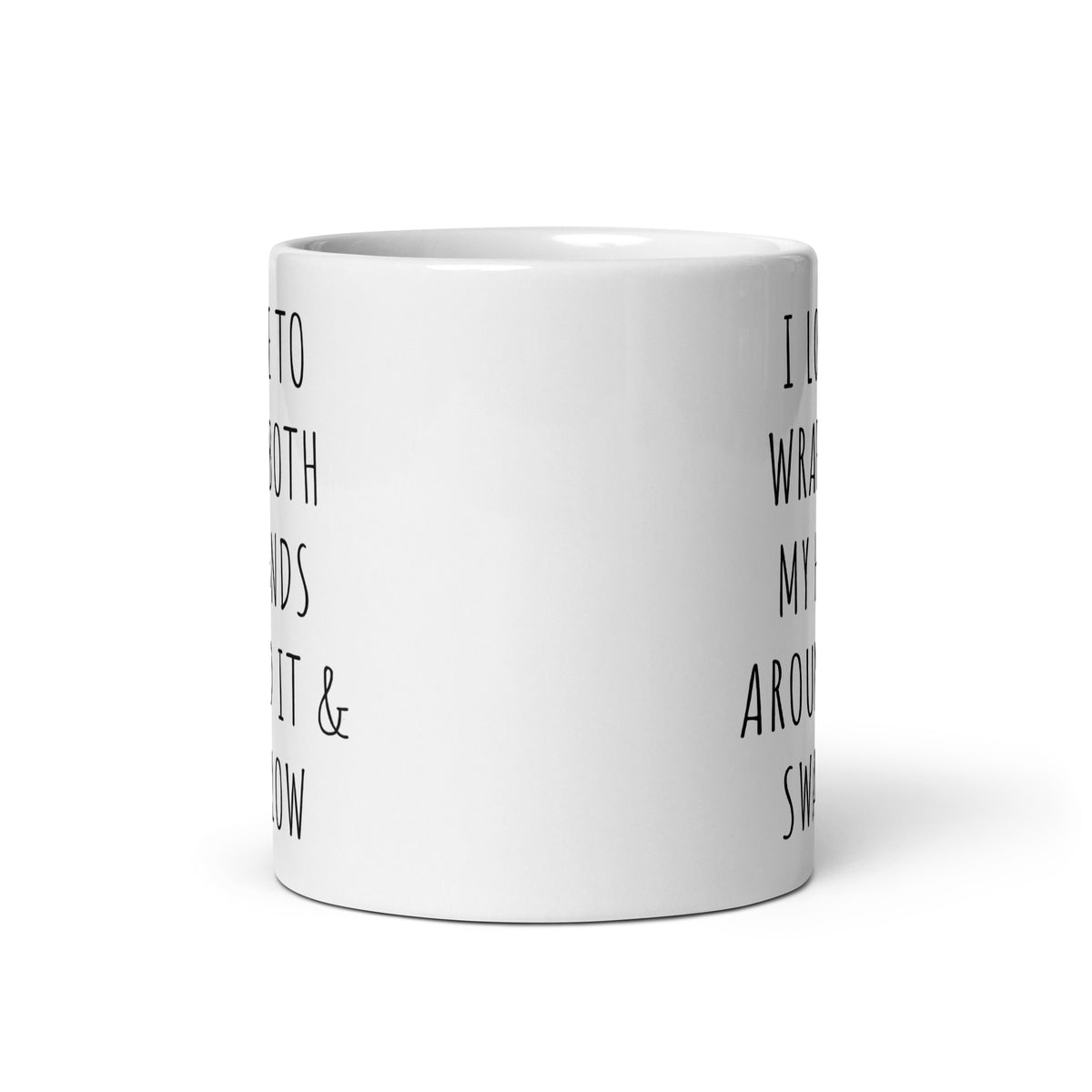 White glossy ceramic mug side view with partial black quote text on the body