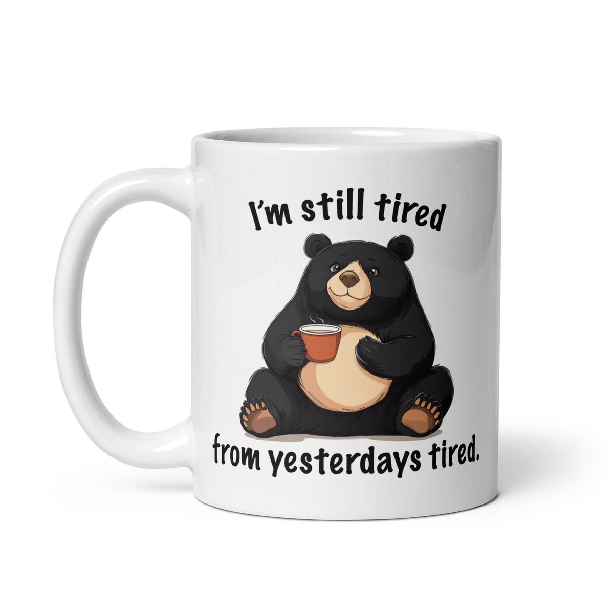 White mug front with black bear holding coffee and “I'm still tired” lettering