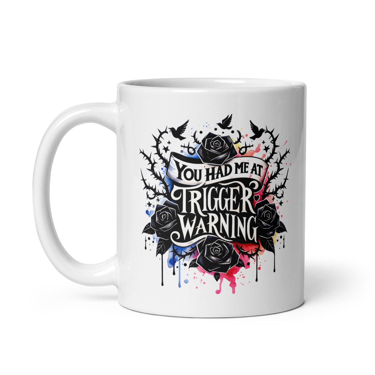 White glossy mug with 'Trigger warning' lettering and colorful splatter rose design