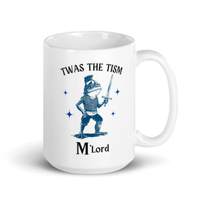 White glossy mug with 'Twas the Tism' and 'M'Lord' and blue knight sword illustration