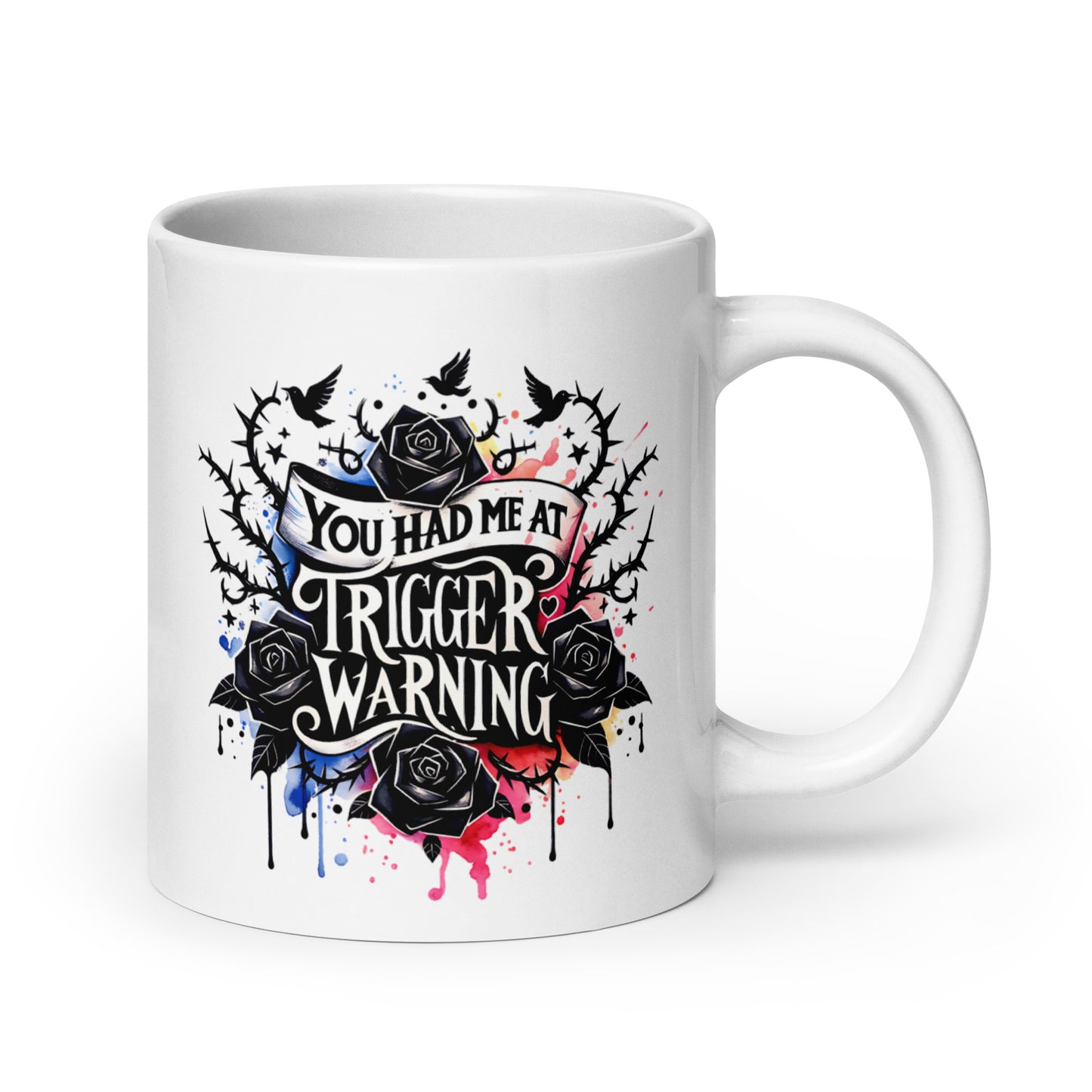 White glossy mug with colorful splatter roses and 'Trigger warning' text