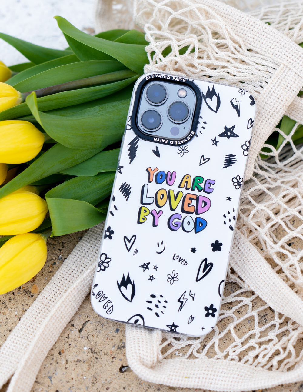 Christian iPhone Case with colorful 'You Are Loved By God' design surrounded by floral doodles