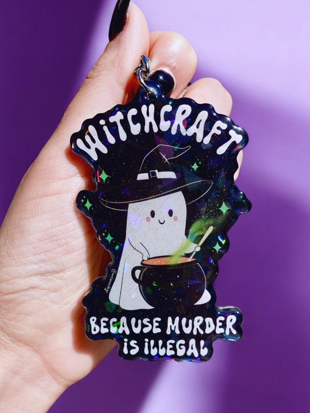 Funny Halloween witch keychain, starry design; text 'MURDER IS ILLEGAL' and 'WITCHCRAFT'.
