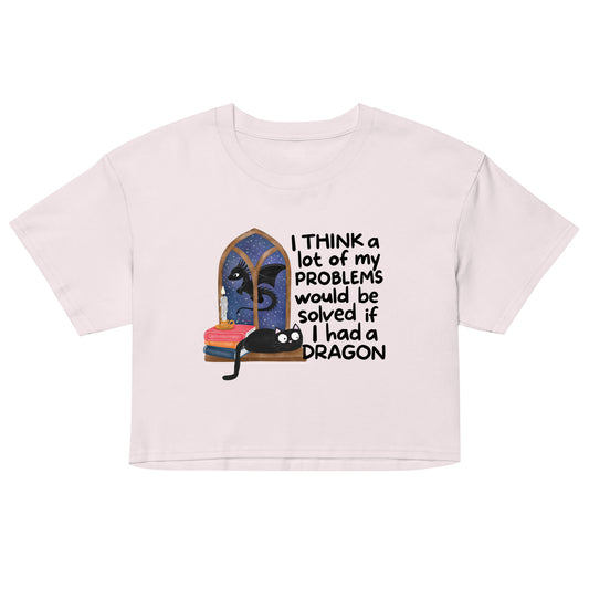 Women’s light pink crop top with dragon character graphic and quote-style text