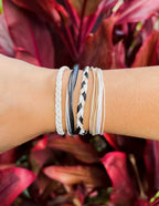 Set of Elevated Faith Christian Jewelry Bracelets in various colors stacked on a wrist