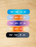 Set of five colorful Christian Stickers featuring the phrase W.Y.J.D. on a wooden background